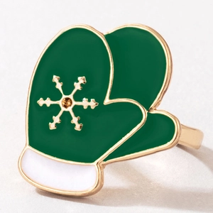 Detailed macro view of a green enamel Christmas glove ring with golden snowflake pattern