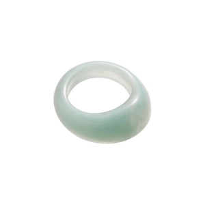 Minimalist geometric light green acrylic resin ring with a thick circular design on white