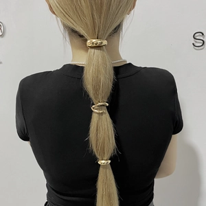 Rear view of gold geometric metal hair rings for ponytail styling on model hair