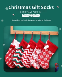 Detailed view of five knitted Christmas stockings with reindeer and snowflake patterns