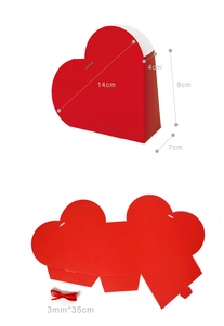 Macro view of red heart-shaped gift box with assembly dimensions and ribbon details