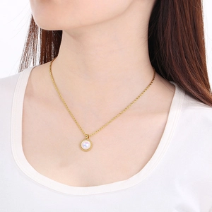Detail of a gold necklace featuring an iridescent gemstone pendant surrounded by small crystals