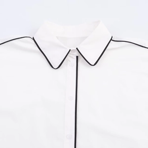 Minimalist white poplin shirt featuring black contrast piping and button-down collar details