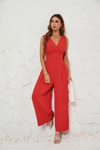 Detail of red sleeveless V-neck wide-leg jumpsuit showing fabric texture and elegant waistline