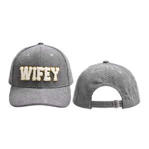 Detail of grey corduroy baseball cap with WIFEY chenille embroidery and gold sequin trim