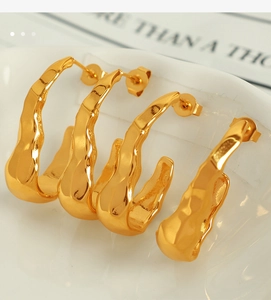 Detailed close-up of 18K gold stainless steel earrings with irregular lava ripple texture