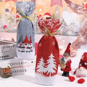 Detail view of festive Christmas wine bottle bags featuring gnome and snowflake prints