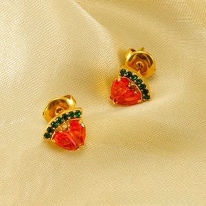 Detail of 18K gold watermelon earrings with heart-shaped red stones and green crystals
