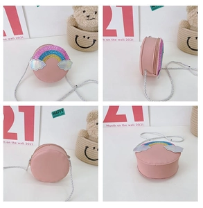 Detailed views of a pink round kids crossbody bag with glitter rainbow and silver strap