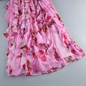 Detail of pink floral halter dress showing layered ruffles and soft chiffon fabric texture