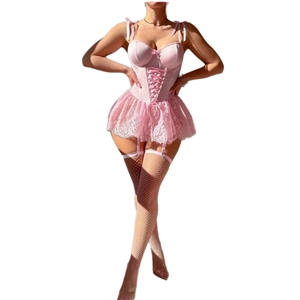 Pink satin corset with lace skirt and white fishnet stockings set on female model