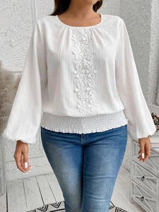 Elegant white long sleeve blouse for women with floral lace trim and smocked waist hem