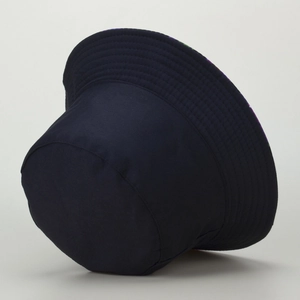 Detail of dark blue cotton bucket hat showing parallel reinforced stitching on the brim