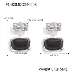 Detail view of square black glass earrings with titanium steel texture and dimensions