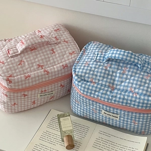 Quilted plaid makeup bags in pink and blue with bow details and top handles