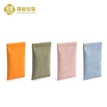 Close-up of portable faux suede sunglasses pouches with automatic spring closure details