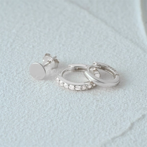 Macro shot of S925 sterling silver earring set with clear zircon and smooth metal finish