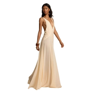 Detail of elegant beige evening dress featuring intricate lace stitching and open back design