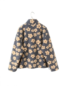 Rear view of grey fleece pullover with yellow flower patterns and adjustable drawstring hem