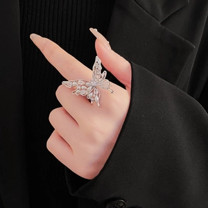 Detail of silver butterfly ring with zircons and pearls on a model hand