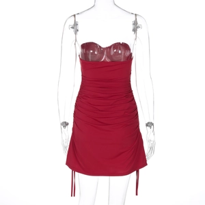 Detail view of red ruched bodycon dress showing side drawstring and fabric texture