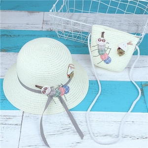 Detail of kids straw sun hat and crossbody bag with cute caterpillar and snail patches