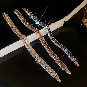 Sparkling crystal tennis bracelets set in colorful white, amber brown, and deep blue