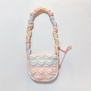 Detail of quilted cloud bag showing pink gradient fabric and drawstring closure