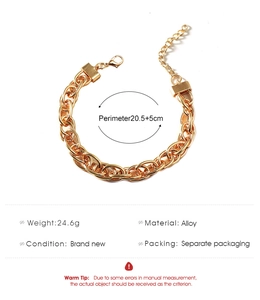 Macro view of gold chunky chain bracelet with alloy links and lobster clasp detail