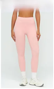 Macro shot of high-waist peach pink yoga leggings with flatlock seams and stretch fabric