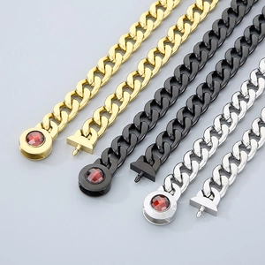 Three Cuban link chains in gold black and silver with red gemstone skull buckles