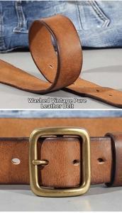 Detail of washed vintage cowhide leather belt showing brass buckle and textured finish