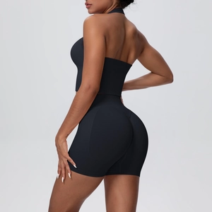 Side view of seamless high-waist shorts and halter neck sports bra in black