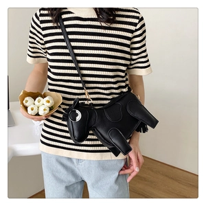 Detailed view of the stylish black pony-shaped leather crossbody bag with gold hardware