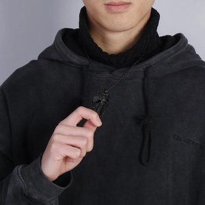 Fashion vintage long sweater chain with black fish bone pendant worn by model on black hoodie