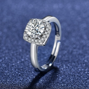 Macro view of a round zircon ring with a halo setting and adjustable silver band