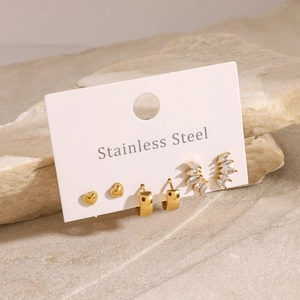 Gold stainless steel earring set with heart, leaf and zircon studs on a stone base