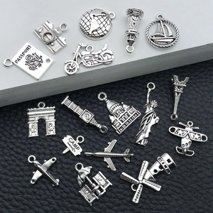Detailed collection of silver alloy travel charms including passport and landmarks