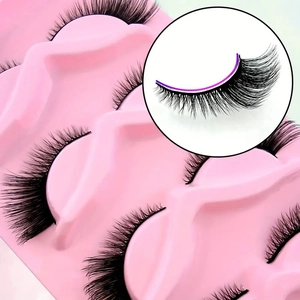 Cat eye faux mink eyelashes with dense volume and black band on a pink tray