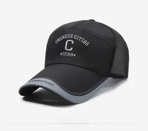 Detail of breathable mesh panel and white embroidery on a black mesh baseball cap
