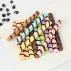 Assorted PVC colorful chocolate wafer sticks with swirl patterns on a white background