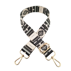 Detail of adjustable geometric strap with gold metal lobster clasps and ethnic pattern