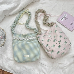 Detailed view of floral lace trim and bow patterns on gentle style canvas tote bags