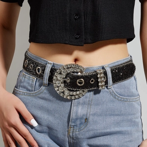 Fashionable black glitter leather belt with round rhinestone buckle and metal eyelets on model