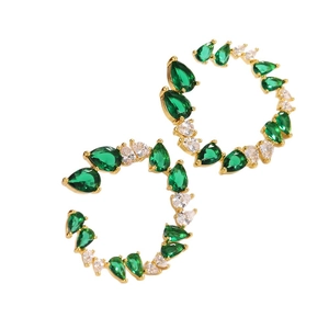 Gold C-shaped hoop earrings with green and white pear-cut cubic zirconia inlays