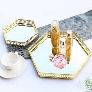 Set of 2 hexagonal gold metal mirror trays with decorative hollow wavy edge design