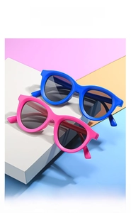 Detailed view of matte blue and pink kids sunglasses with UV protection lenses