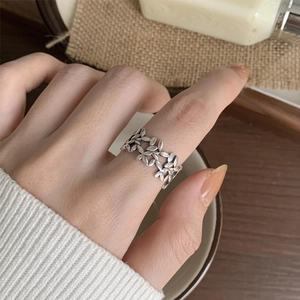 Close-up of intricate镂空leaf pattern on a polished S925 sterling silver open ring