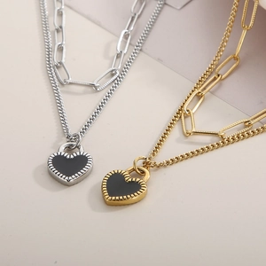 Detailed macro view of double-layered titanium steel necklaces with black heart pendants