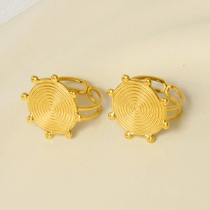 Detailed view of two gold spiral swirl rings with small beaded edge and open band